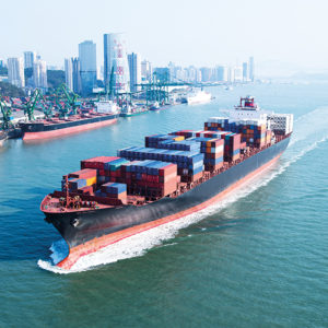 Marine industry: cargo ship sailing from shipping port.